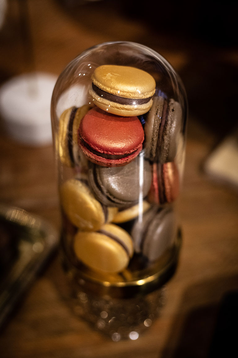 An elegant gold based cloche full of macarons by GC Couture at Maison Assouline